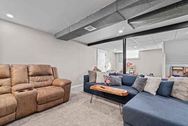 living room with a paneled ceiling and light colored carpet