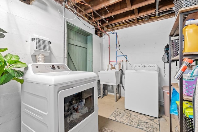 clothes washing area featuring sink and washing machine and clothes dryer