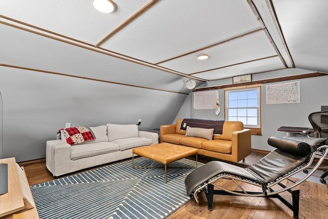 living room with hardwood / wood-style floors and vaulted ceiling