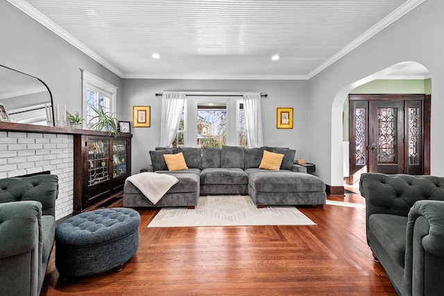 living room with crown molding, a healthy amount of sunlight, and parquet floors