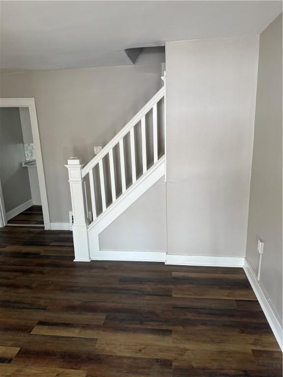 stairs featuring hardwood / wood-style floors