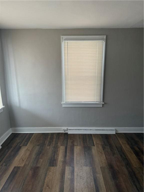 unfurnished room featuring dark wood-type flooring