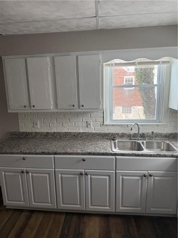 kitchen featuring white cabinetry, sink, and dark hardwood / wood-style flooring