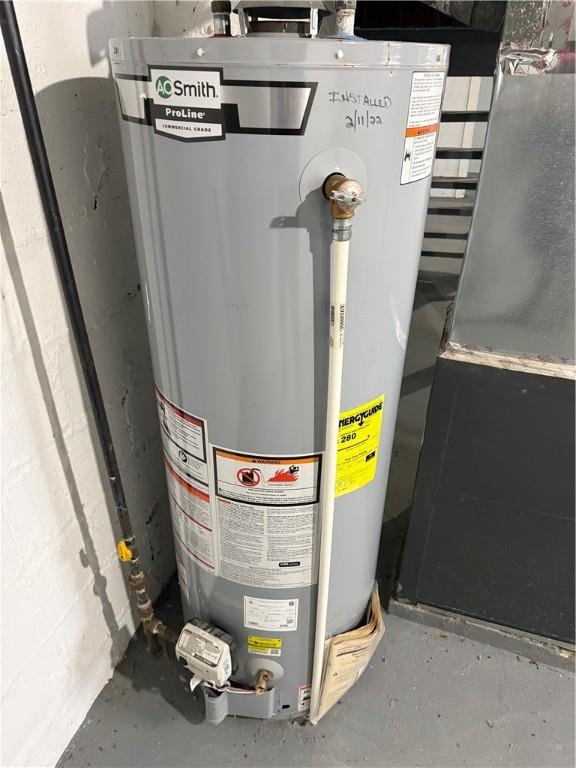 utility room with gas water heater