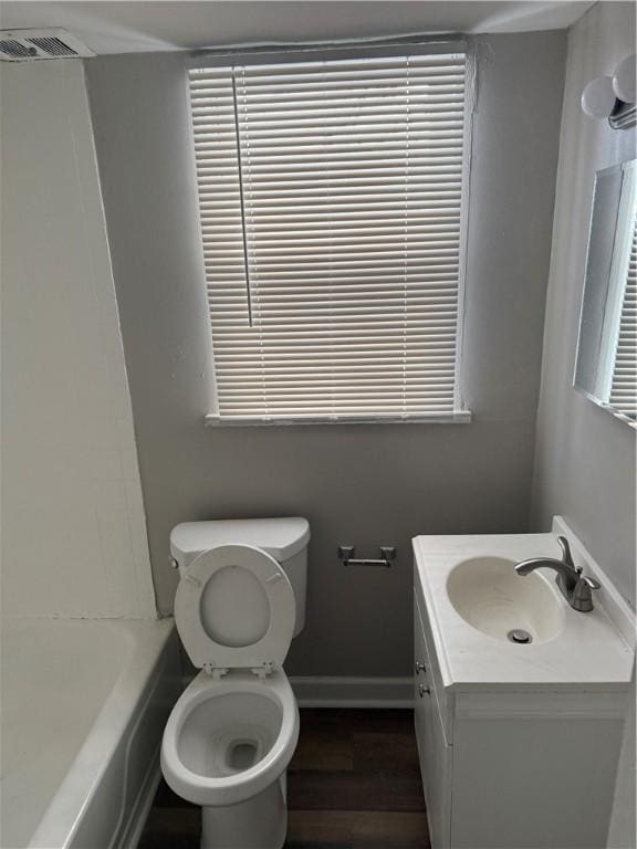 bathroom featuring vanity, toilet, and hardwood / wood-style floors