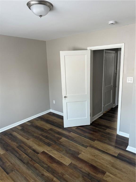 unfurnished bedroom with dark wood-type flooring