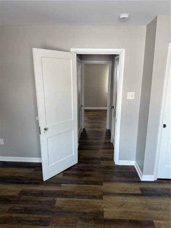 corridor featuring dark wood-type flooring