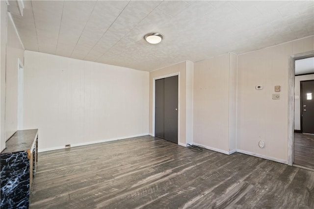 unfurnished room with dark hardwood / wood-style floors