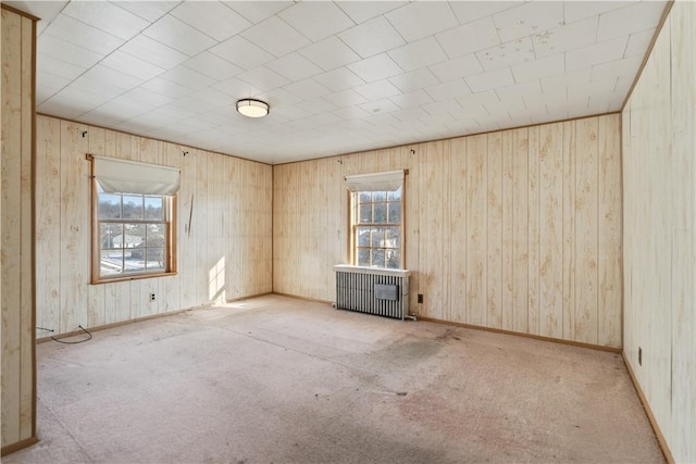 carpeted spare room featuring radiator