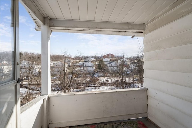 view of snow covered back of property