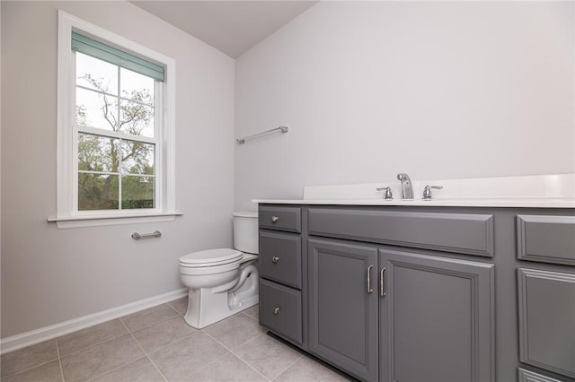 bathroom featuring vanity, tile patterned flooring, and toilet