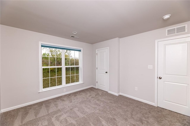 empty room featuring light carpet