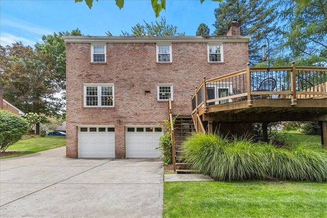 back of property featuring a wooden deck, a garage, and a yard