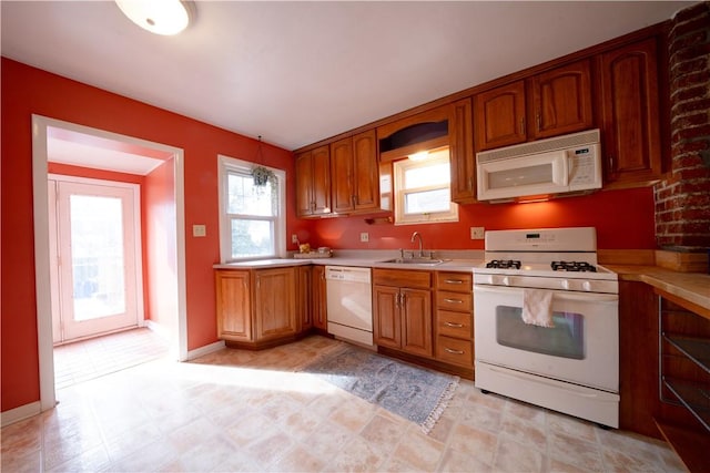 kitchen featuring white appliances and sink