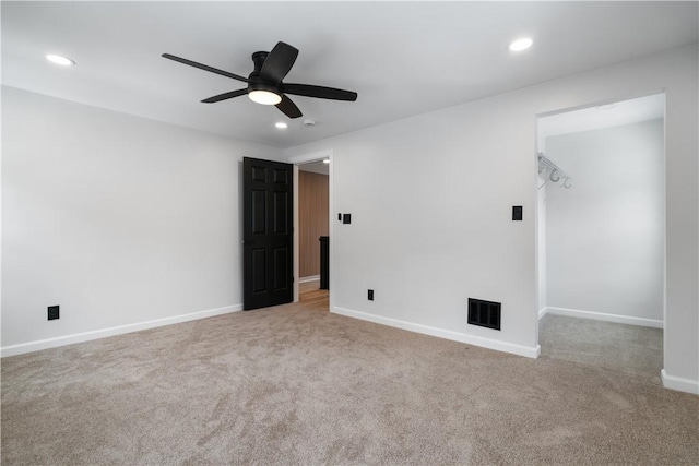 unfurnished room featuring light carpet and ceiling fan