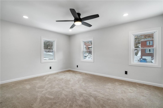 spare room featuring carpet and ceiling fan