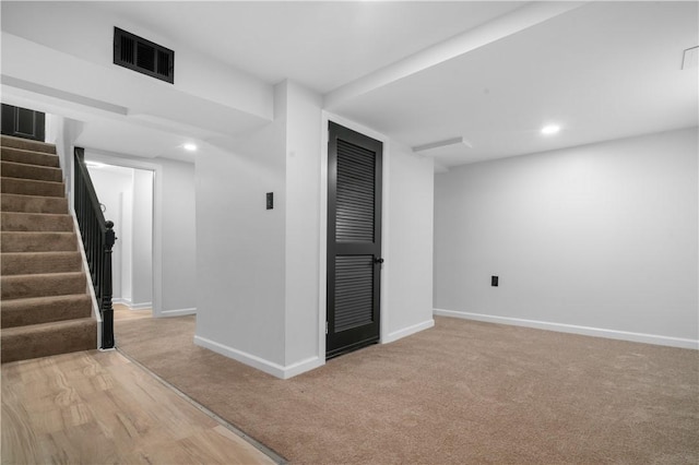 basement featuring light colored carpet