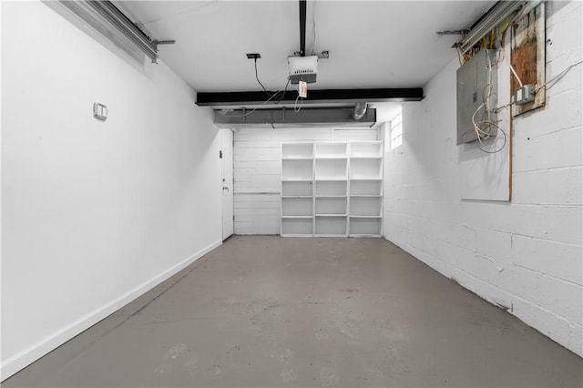 garage with a garage door opener and electric panel