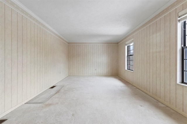 empty room with light colored carpet and ornamental molding