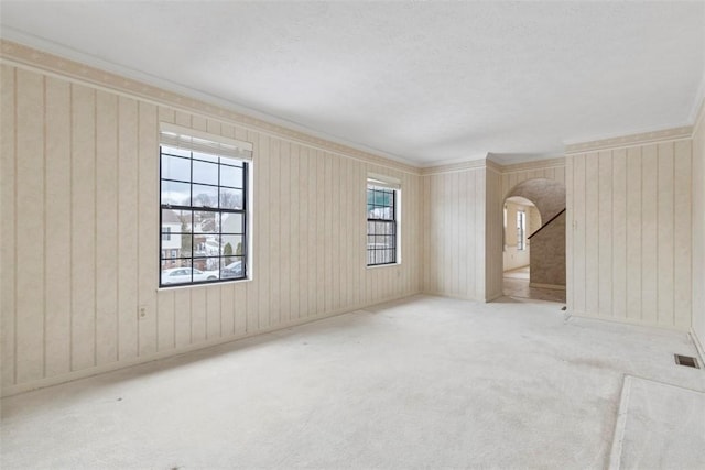 carpeted spare room with crown molding