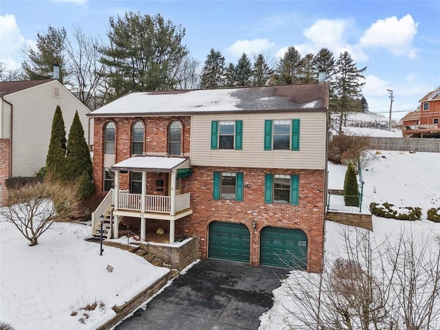 view of front of home featuring a porch and a garage