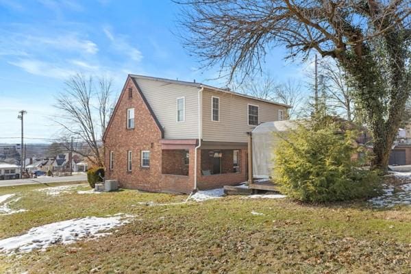 back of house with a yard and central AC unit