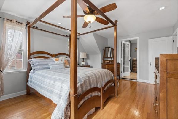 bedroom with ceiling fan and light wood-type flooring