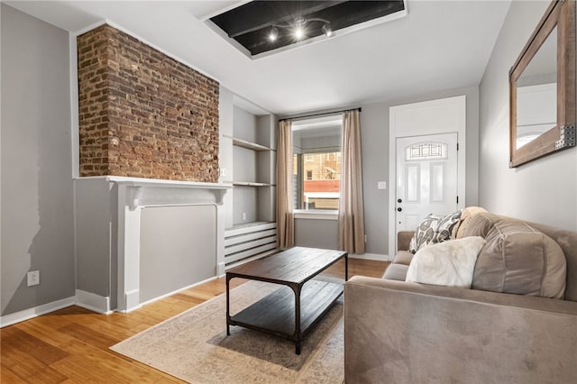 living room featuring hardwood / wood-style flooring and built in features