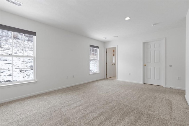 carpeted spare room with plenty of natural light