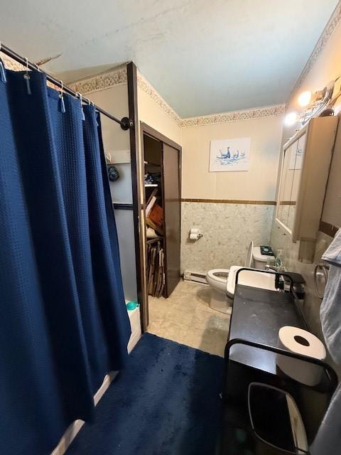 bathroom featuring vanity, toilet, a shower with shower curtain, and tile walls