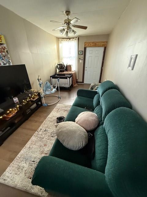 living room featuring hardwood / wood-style flooring and ceiling fan