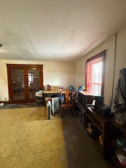 misc room featuring radiator and french doors