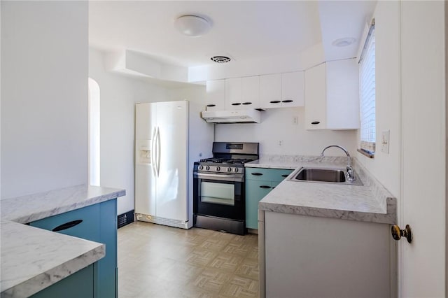 kitchen with stainless steel range with gas cooktop, sink, white cabinets, light parquet floors, and white fridge with ice dispenser