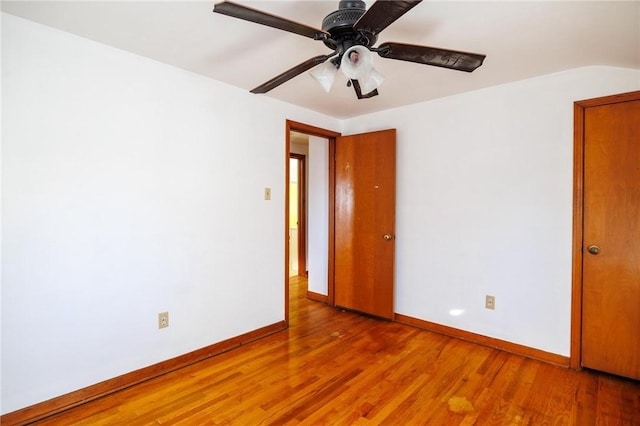 empty room with ceiling fan and wood-type flooring