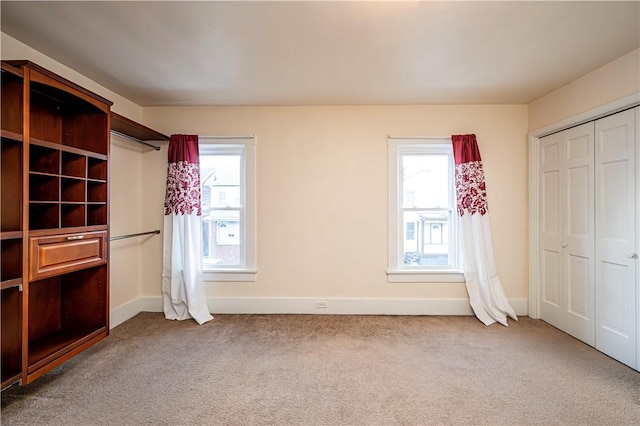 unfurnished bedroom with carpet floors and a closet