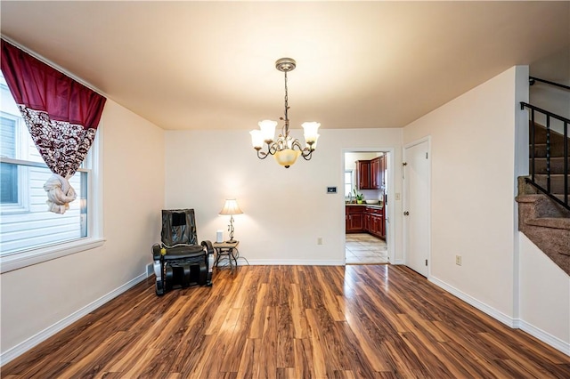 dining space featuring dark hardwood / wood-style flooring and a chandelier