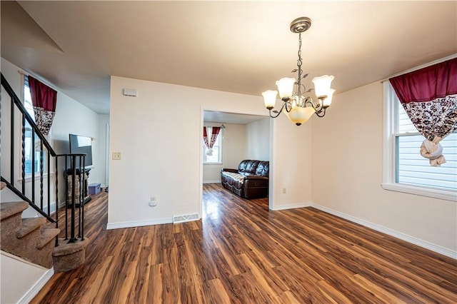 interior space featuring an inviting chandelier and dark hardwood / wood-style floors