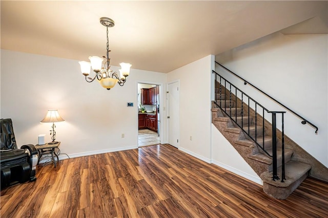 interior space featuring dark wood-type flooring and a chandelier