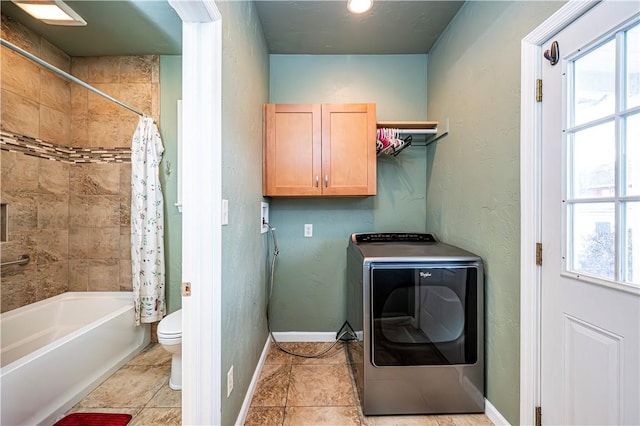 washroom with washer / dryer, light tile patterned floors, and a wealth of natural light