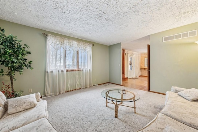 carpeted living room with a textured ceiling