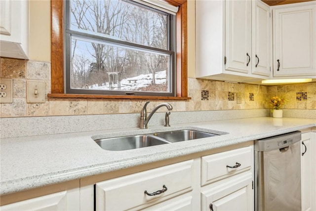 kitchen featuring white cabinetry, sink, backsplash, and dishwasher