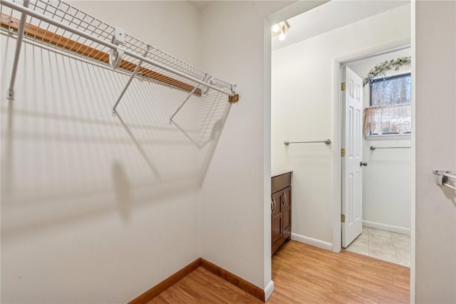 spacious closet featuring light wood-type flooring