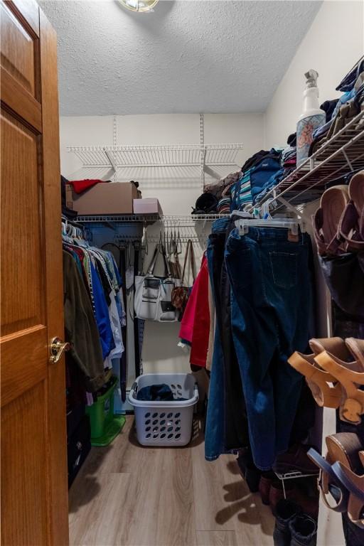 spacious closet featuring hardwood / wood-style flooring