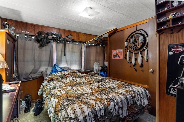 carpeted bedroom featuring wooden walls