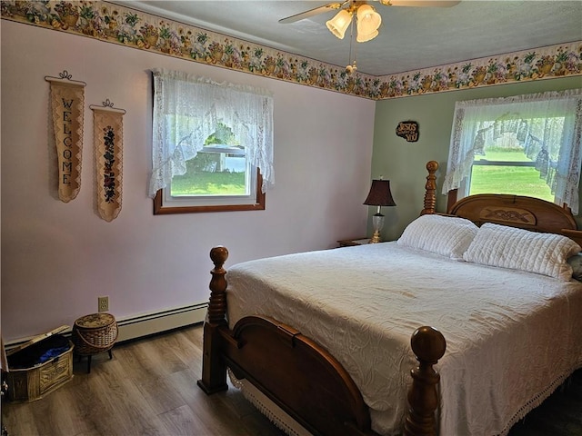 115 Mill Creek Rd, Mill Creek, PA 16145 - bedroom with baseboard heating, wood finished floors, and ceiling fan