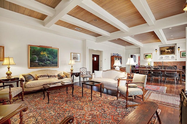 living room featuring coffered ceiling, hardwood / wood-style flooring, beam ceiling, and visible vents