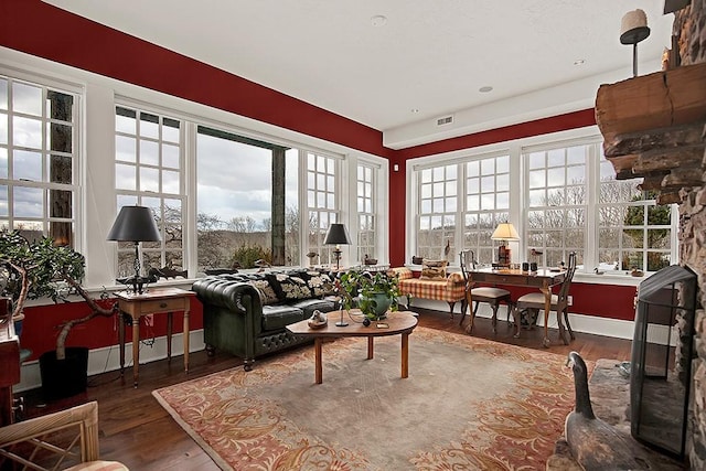 living area with wood finished floors and visible vents