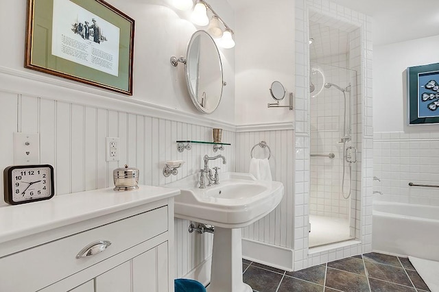 bathroom with tile patterned flooring, a shower stall, a bath, and a wainscoted wall