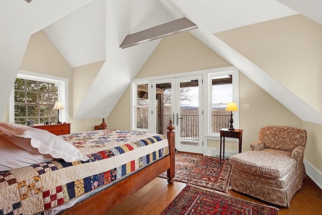bedroom with lofted ceiling, wood finished floors, and access to exterior