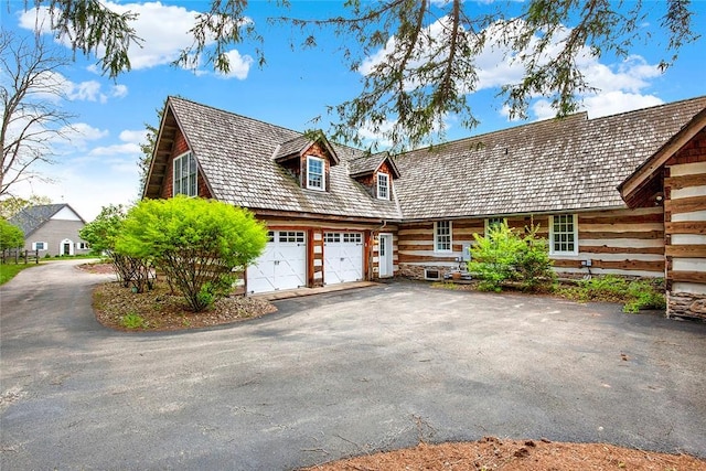 log cabin featuring driveway